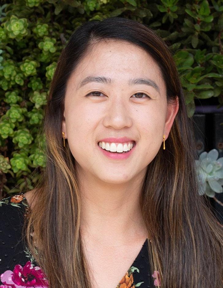 portrait of student Christine Leung in front of the Pitzer Green Wall